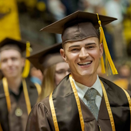 a person in a cap and gown at graduation