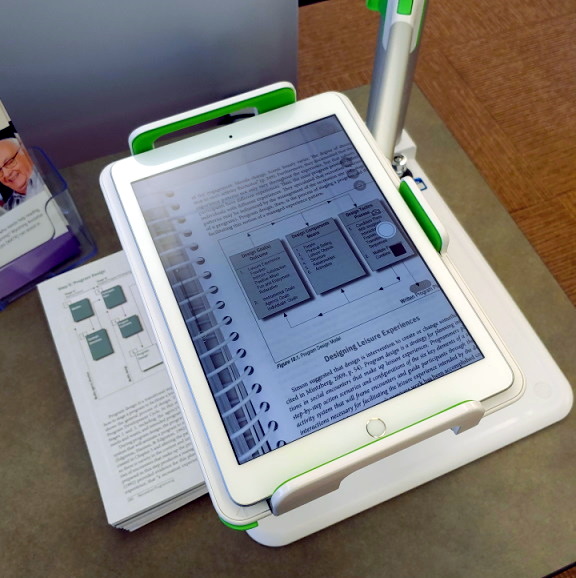 Belkin device stand being used to magnify text