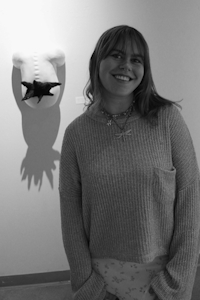 Amelia Marrlatt posing in front of some art