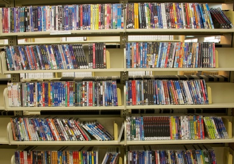 A shelf of movies in the media collection in Coe Library.