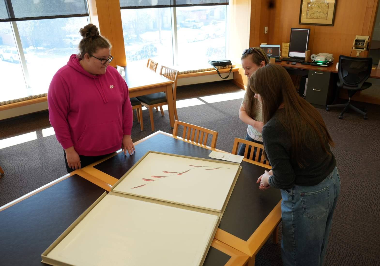 UW Libraries employees examine the new addition to Special Collections