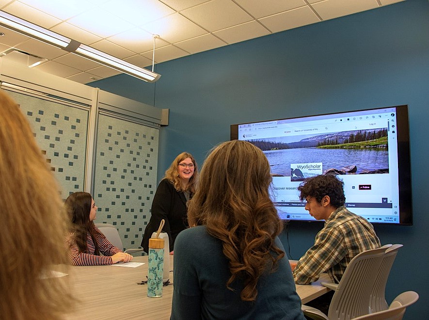 A librarian speaking in a study room.