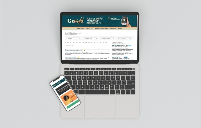 overhead view of a laptop and cell phone with GoWyld databases featured