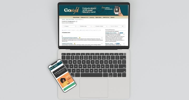 a phone and laptop with WYLD databases on the screen