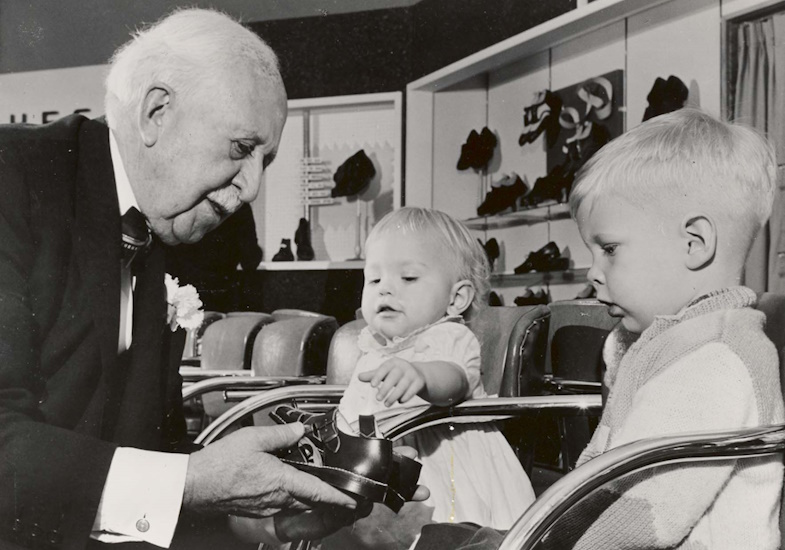 JC Penney helping children try on shoes in 1958