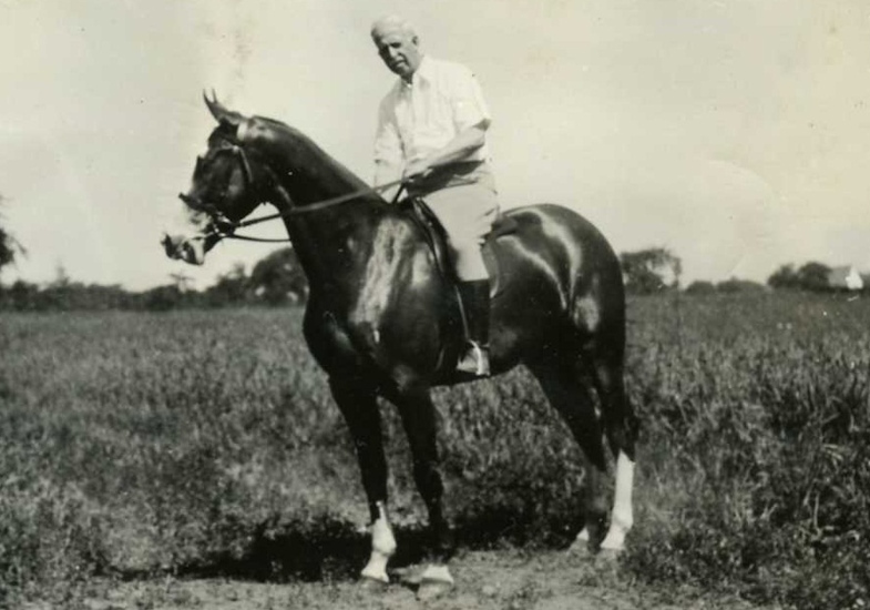 JC Penney riding a horse.