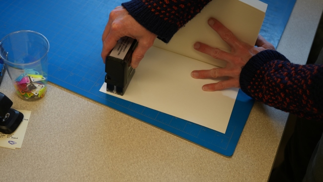 Processing a library book.