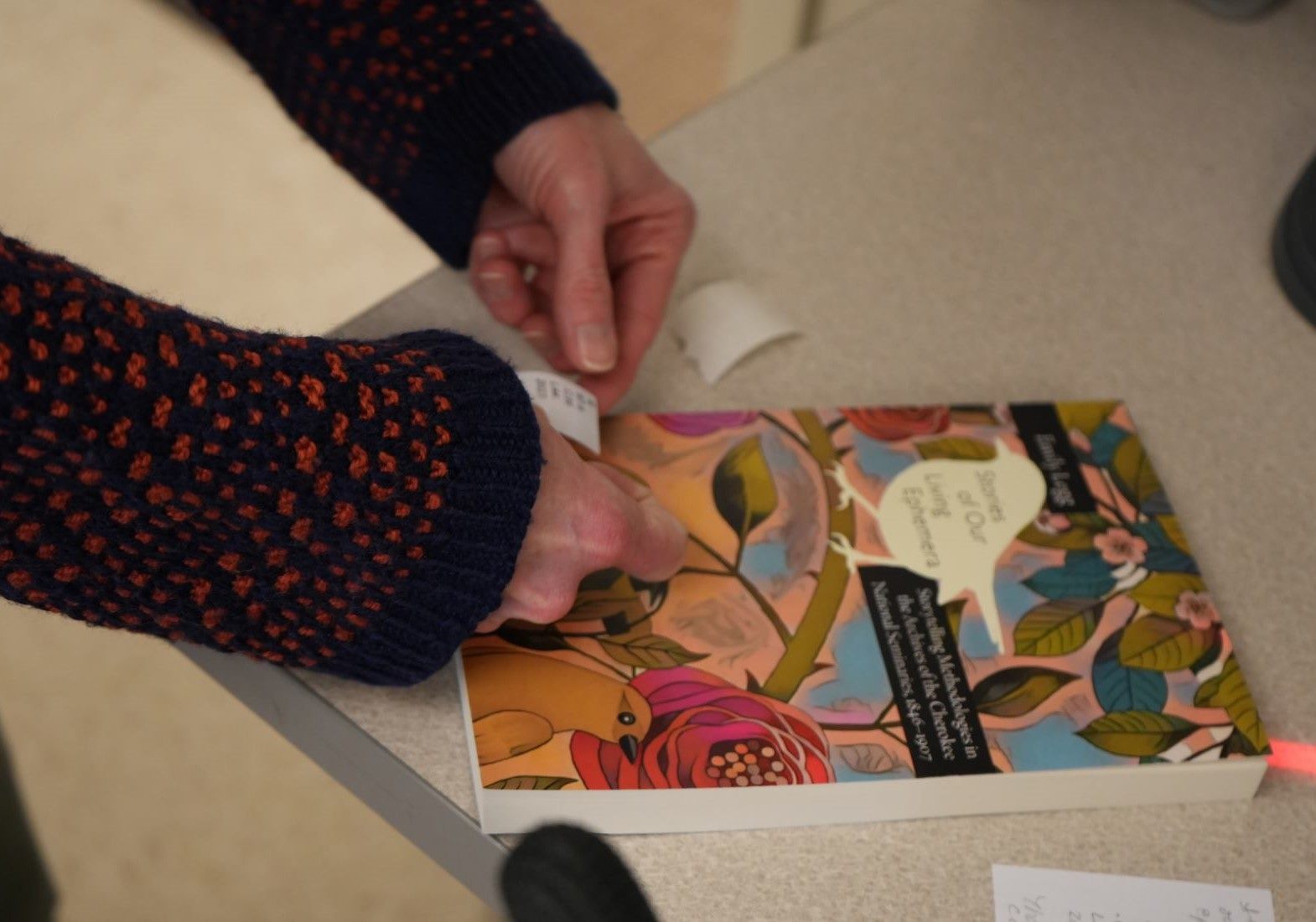 A book being labeled.