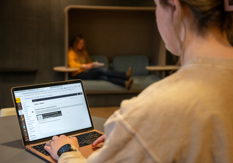 A student working on a laptop.