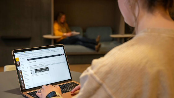 student working on a laptop in Coe Library