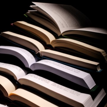 Open books laid on top of each other.