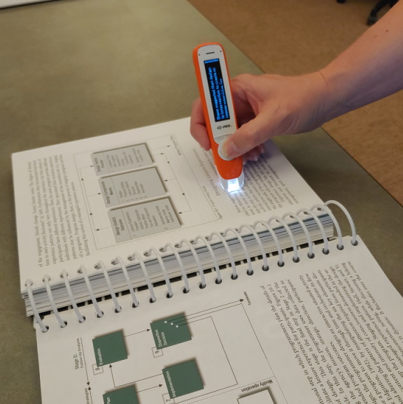 C-Pen being used with a manual by patron