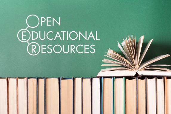 textbooks against a blackboard with one textbook open. Text that reads "Open Educational Resources"