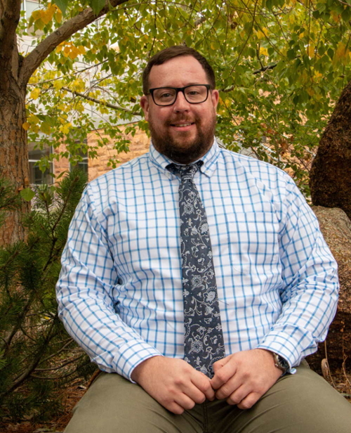 Denis Shannon sitting outside Coe Library