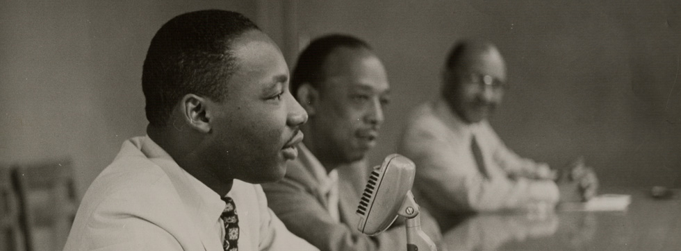 Martin Luther King, Jr. speaking into a microphone