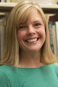 headshot of Cass Kvenild in the stacks