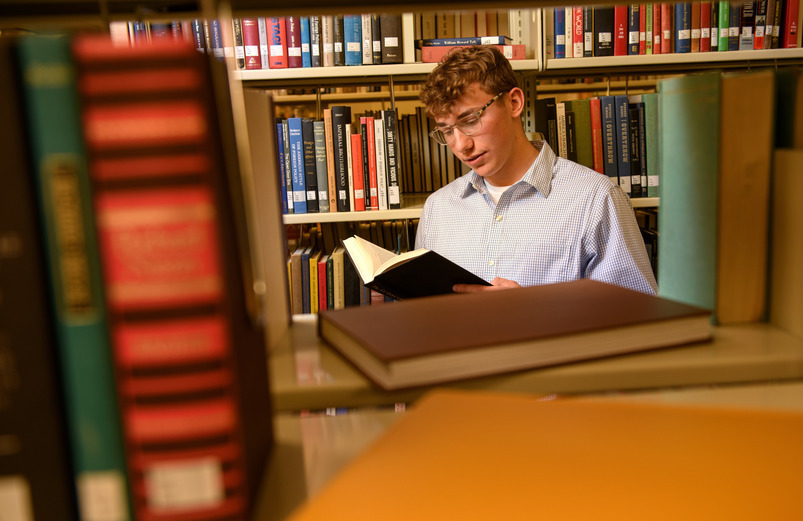 A student looking for material in the stacks.