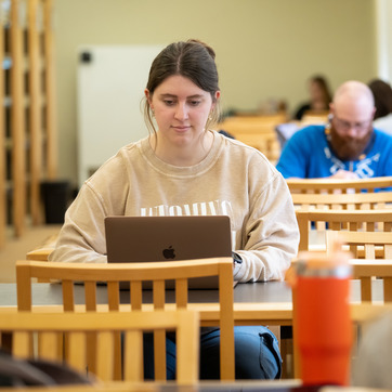 A student working at a table.