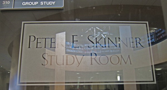 Image of a glass window of a study room in Coe Library. The etching on the glass reads "Pete E. Skinner Study Room"