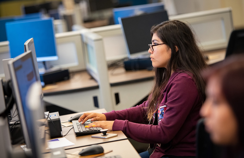 A student working at a computer station.