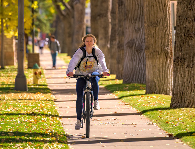 Student biking on campus