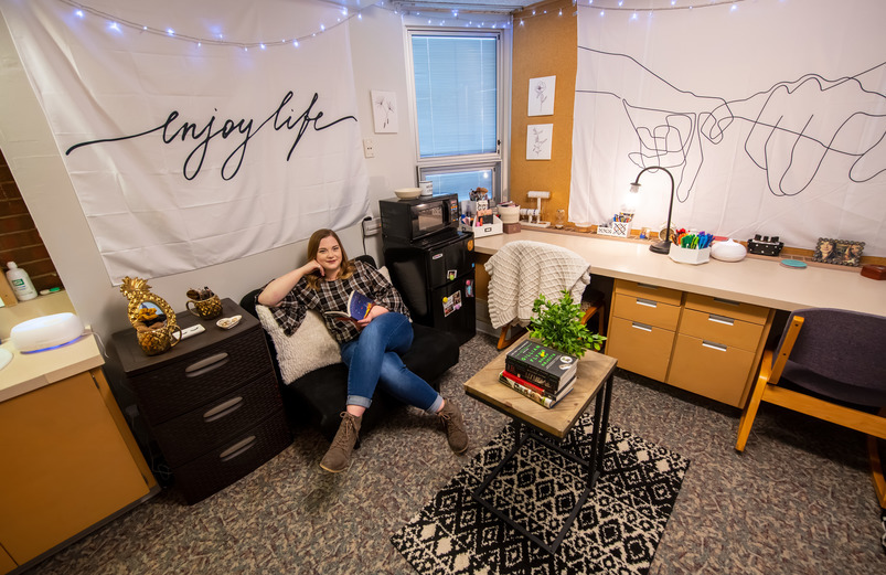 Student hanging out in her double room in Orr Hall