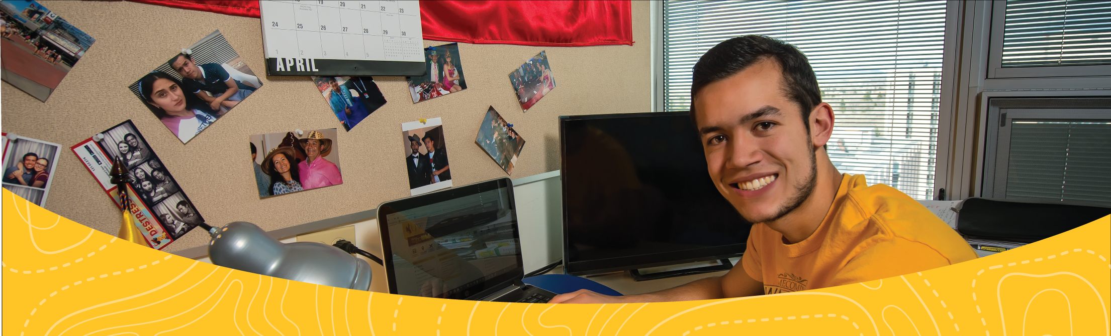 Male student sitting in his Residence Hall room at his desk