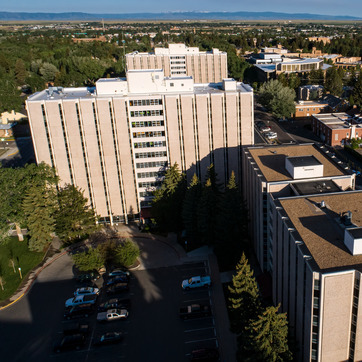 Aerial image of Residence Hall with cars parked