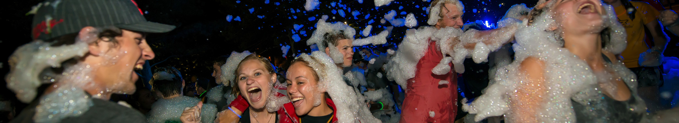Students engaged in activities like a bubble party event in the residence halls