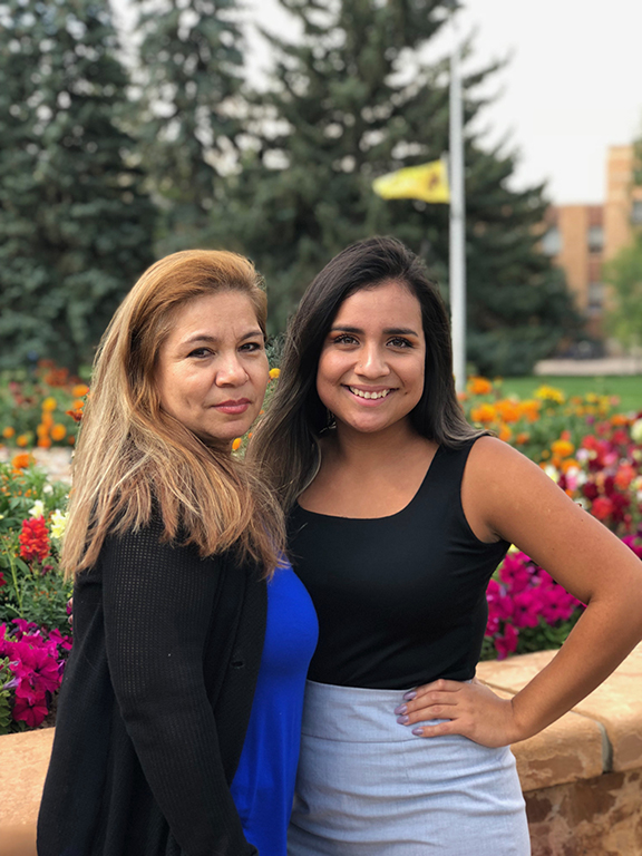 Graduate Jessica Gutierrez with relative in prexy's pasture