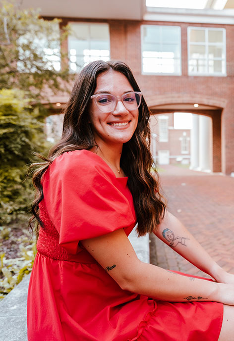 Woman in red dress smiling.
