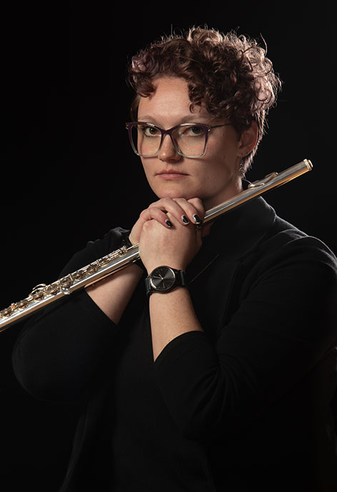 Picture of person holding a flute.