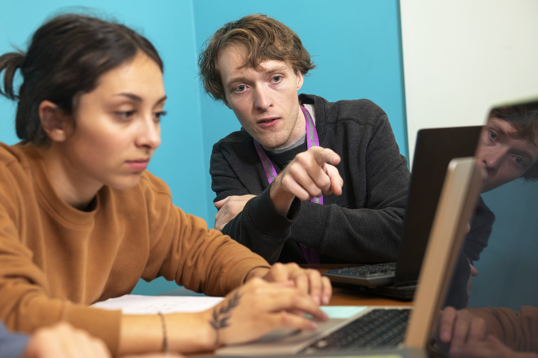 Tutor working with student at a computer