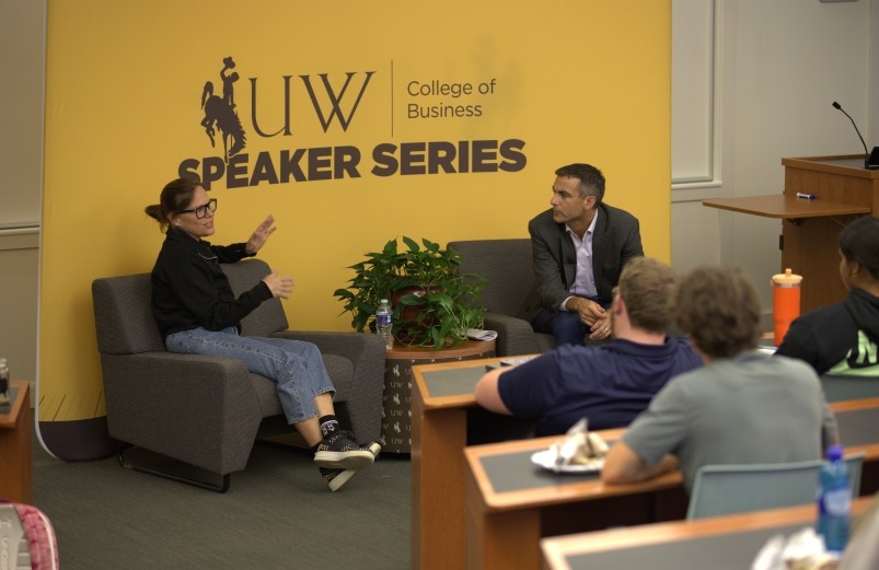 Jennifer Sey and Dean Beaulier speaking at the front of an auditorium during the Executive Speaker Series