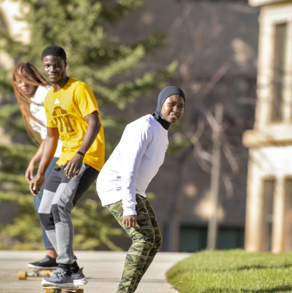 Students skateboarding on campus