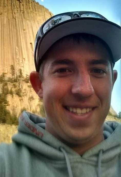 candid photo of Kyle Kuhn with devils tower in the background