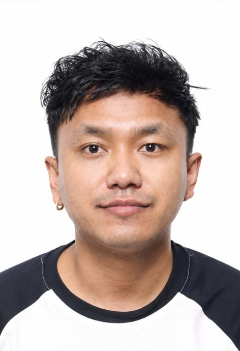 photo of bibek magar in a white baseball t-shirt with black sleeves and collar, taken against a white background.