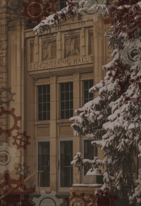 low contrast image of the front enterance to the engineering hall with a snow-covered pine tree in the foreground. There is a transparent overlay of gears around the edges of the photo.