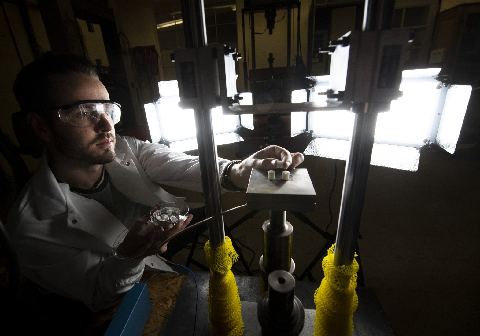 a mechanical engineering graduate student prepares an expirement to test for failure in composite materials