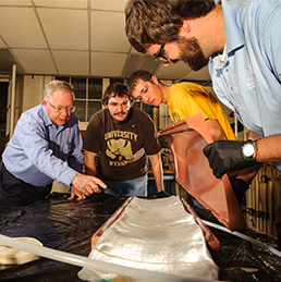A number of students are recieving instruction in an engineering lab