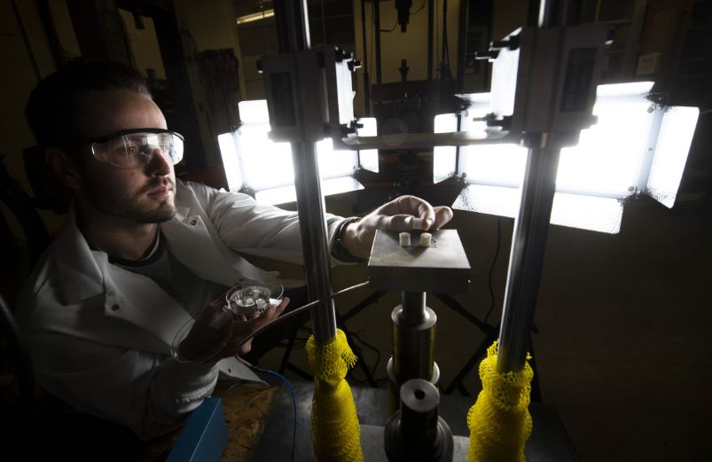 photo of me student conducting and experiment in solid mechanics research