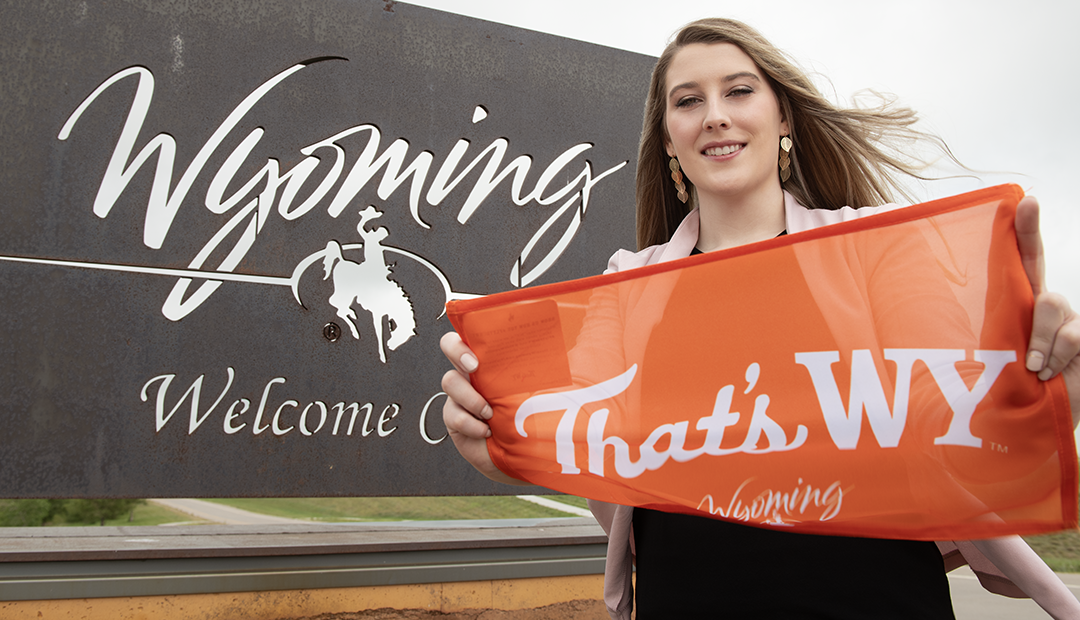 "That's WY" marketing campaign flag promoting UW tourism held by UW graduate