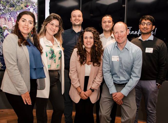 7 phd students posing for a photo at the mountain west research symposium