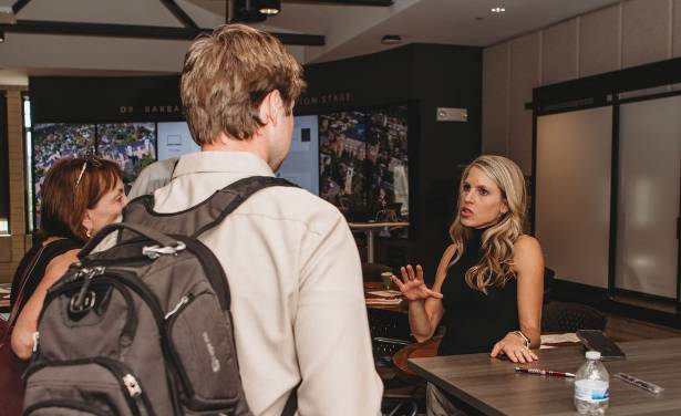 three people speaking at the reception to mwrs