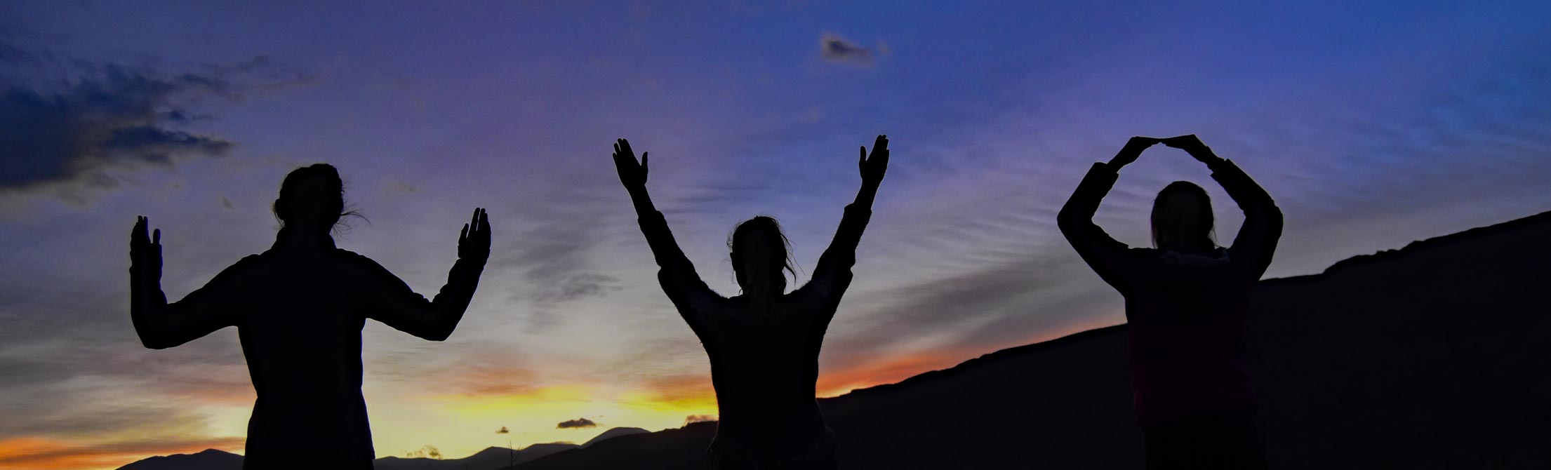 3 students form the letters W Y O with hands in Argentina (Study Abroad 2015)