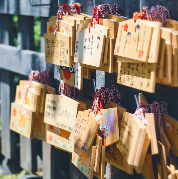 Votive plaques hanging on a fence