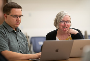 Music education faculty assisting a graduate student in class