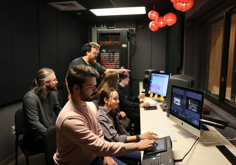 Faculty teaching how to record music in audio & technology class