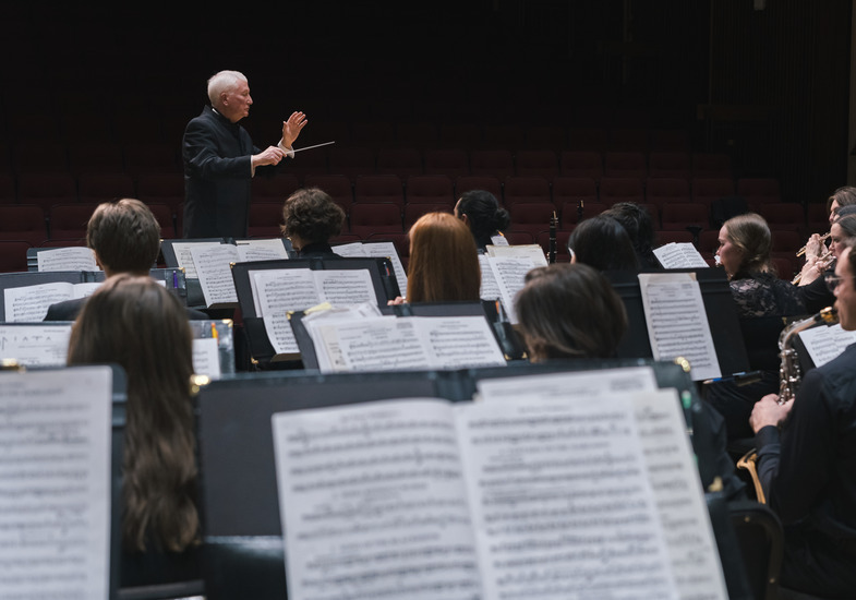 conductor behind sheet music