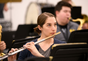 student plays flute